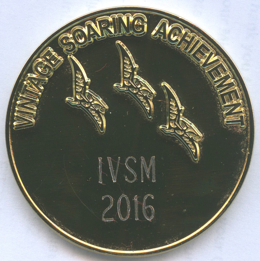 Vintage Achievement Coin back face. Bronze in color with "Vintage Soaring Achievement" embossed around the top edge. 3 bird silhouettes are under the text. The bottom half of the coin is blank for engraving.  This particular one is engraved "IVSM 2016"