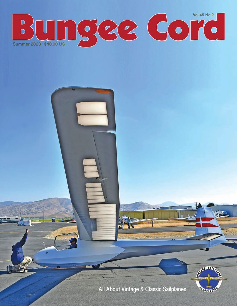 A picture of the cover of Bungee Cord magazine. A white glider is shown preparing for takeoff.